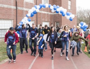 The runners representing Cardinal Cushing Center in the Boston Marathon set off on a victory lap with the students of the center.